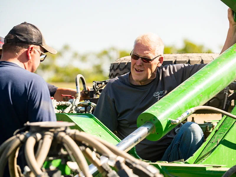 Two men talking by a planter