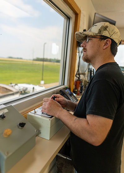 A man checking grain samples.
