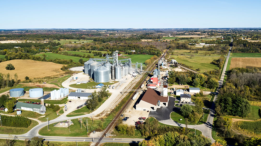 Aerial photo of a cooperative with a town in the background.