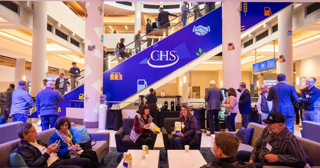 People sitting on couches in a convention center.