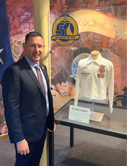 Man standing next to a jacket.