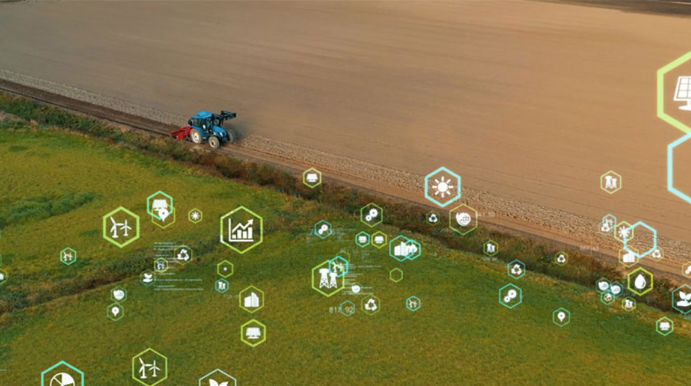 An aerial view of a tractor on a farm with digital and technical-looking clipart surrounding it.