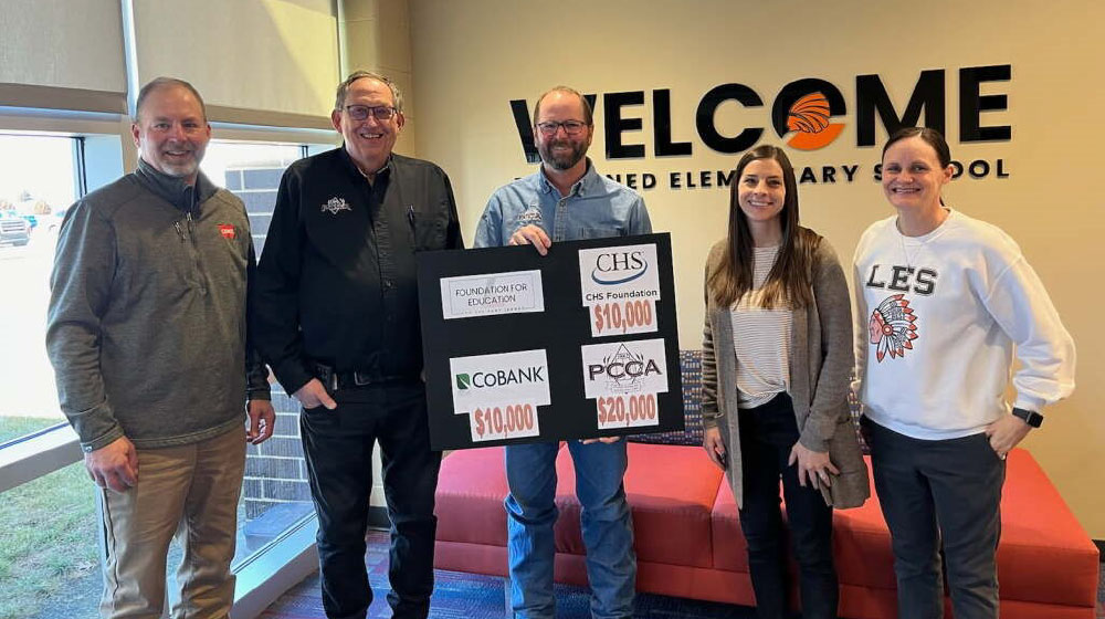 Three men and two women holding up a sign with Foundation for Education grants.