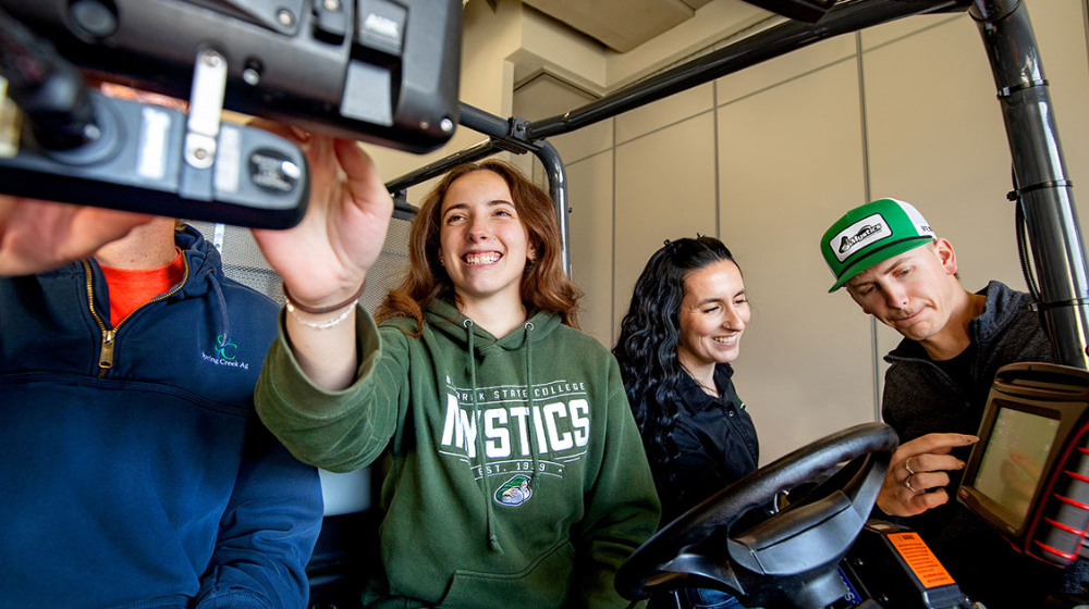Four people testing precision ag equipment.