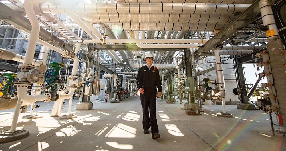 Man walking through a refinery