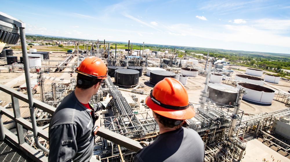 Two men overlooking a refinery.