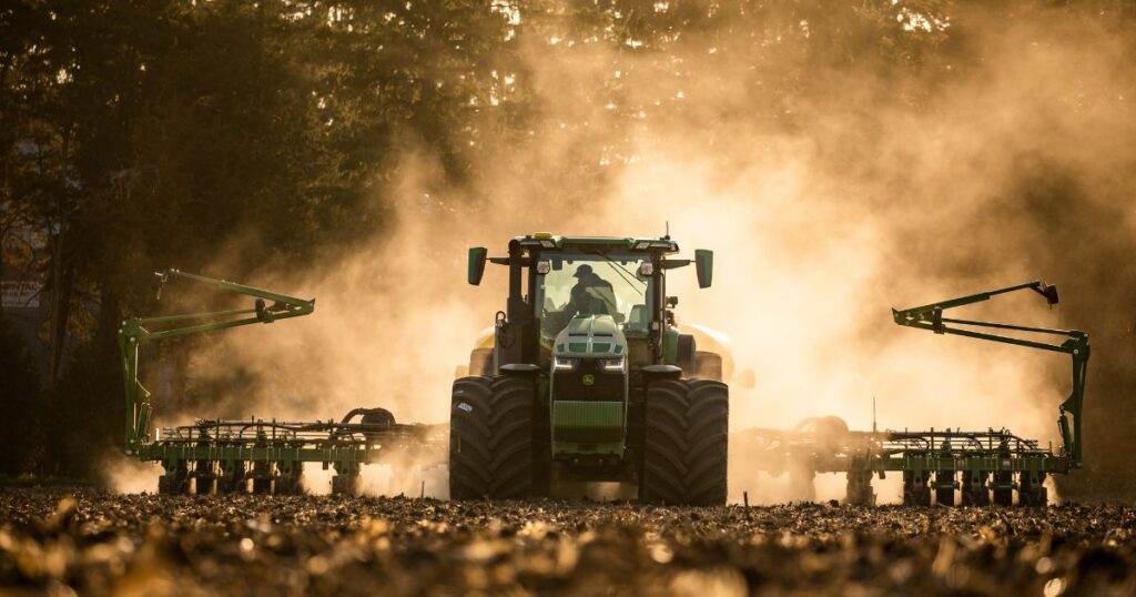 A tractor and planter in a field.