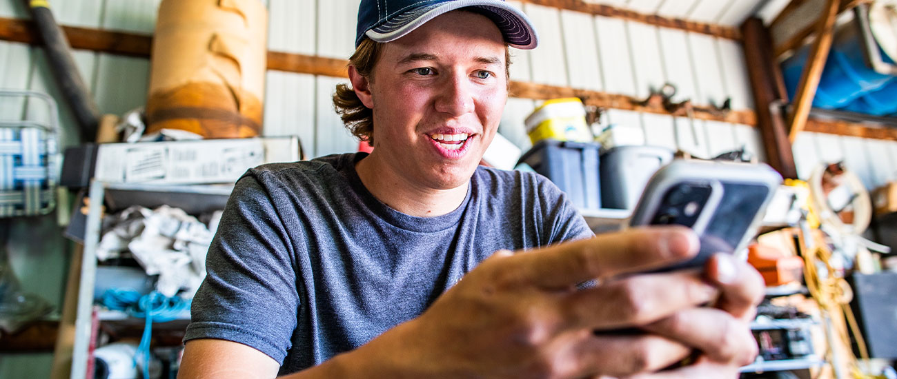 Man smiling and looking at his phone