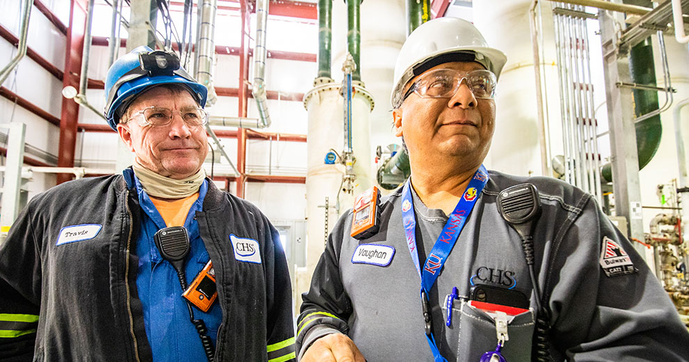 Two workers inside a refinery.