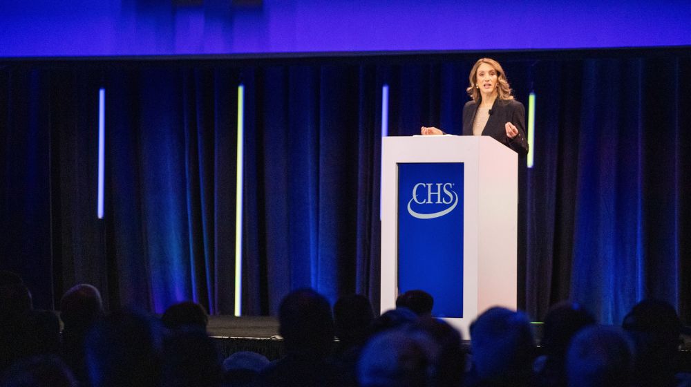 Woman on stage speaking at podium